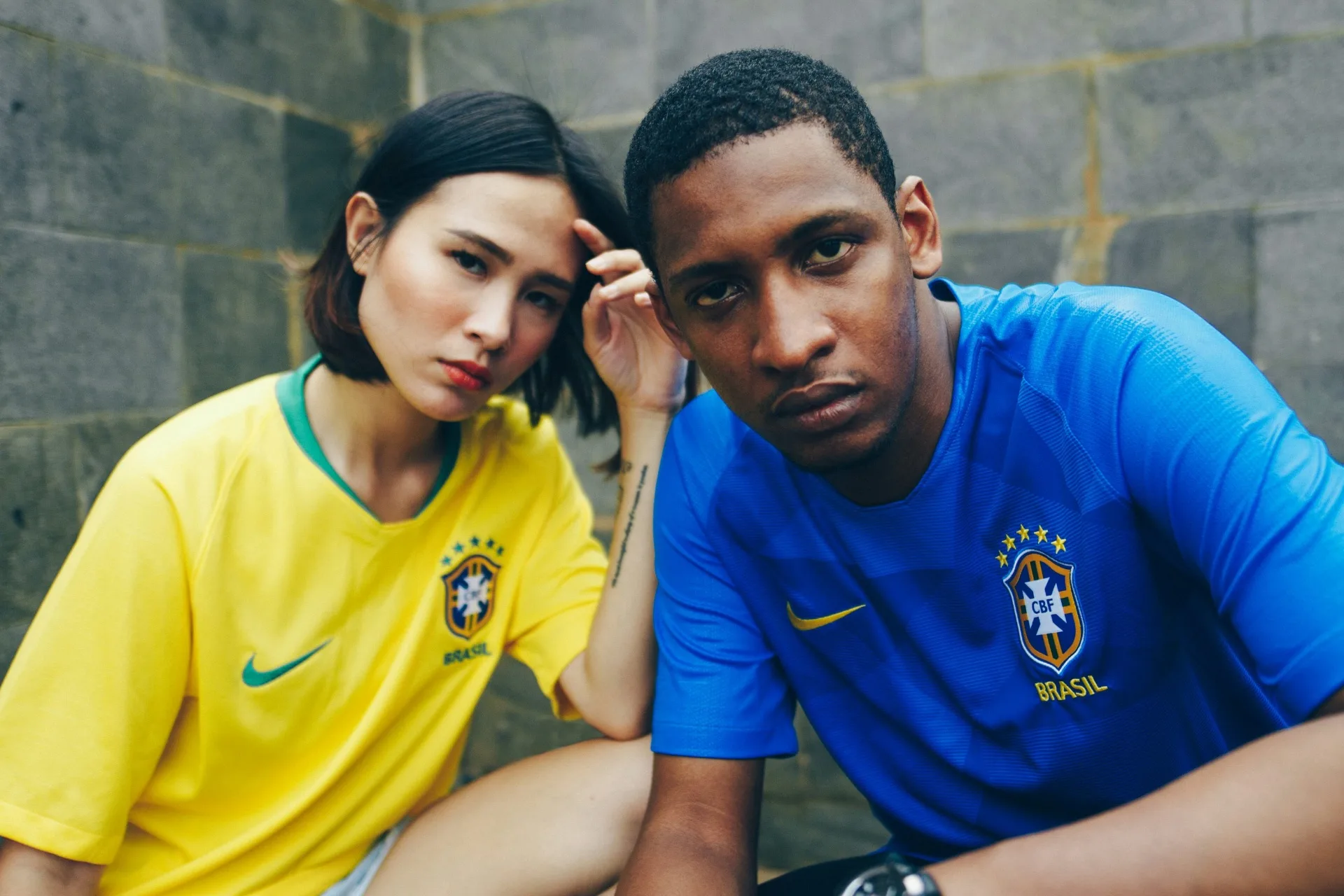 Two fans wearing authentic Brazil home and away national team jerseys